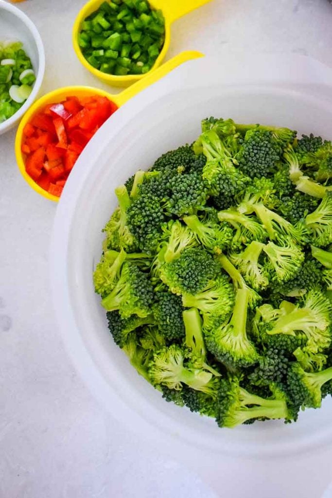 chopped broccoli, peppers, and scallions in measures