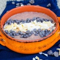 Chocolate Chia Pudding recipe in an orange bowl with coconut and chocolate chips on top