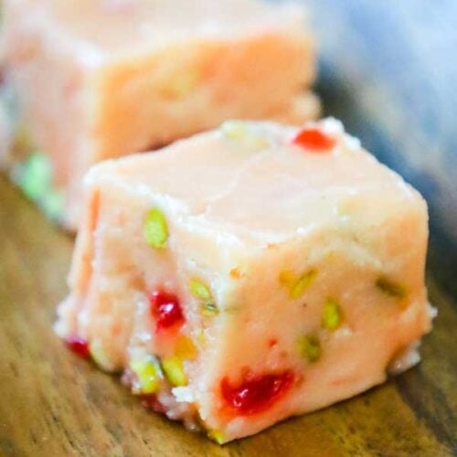 pieces of eggnog fudge on a wooden tray